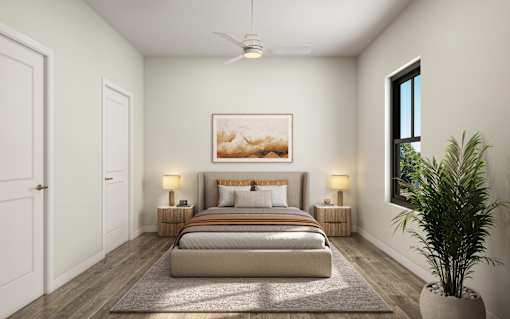 A bedroom with a large bed, a ceiling fan, and a painting on the wall.