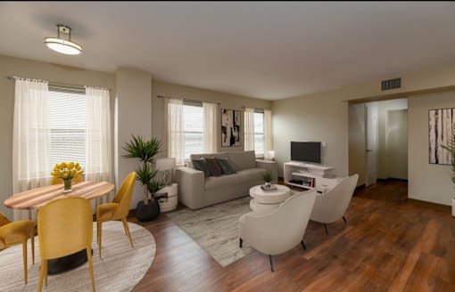 A living room with a wooden floor and furniture.