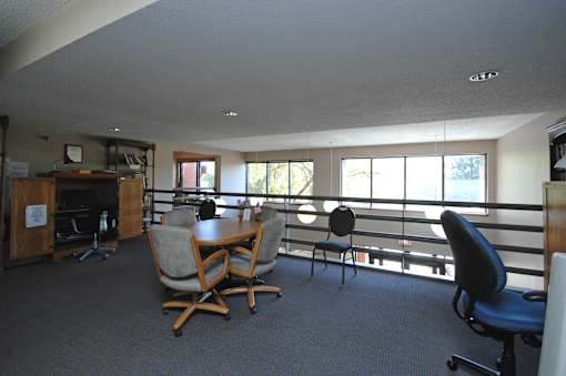 A conference room with a table and chairs.