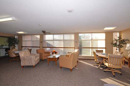 A living room with a couch, chairs, and a coffee table.
