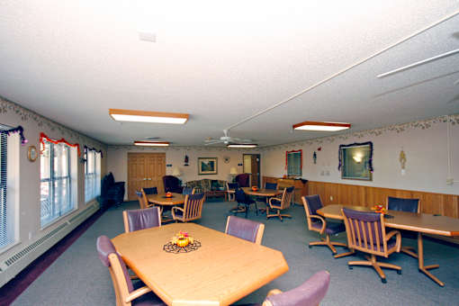 A room with a table and chairs in it.