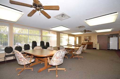 A conference room with a table and chairs.