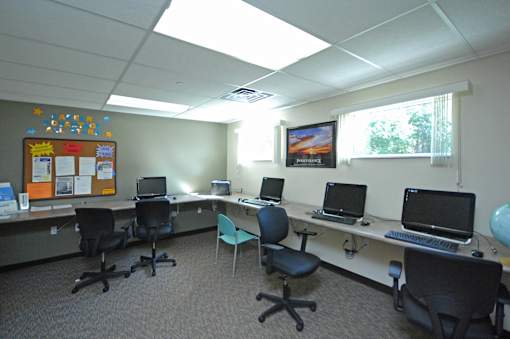 A room with a white ceiling and a bulletin board on the wall.
