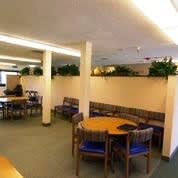 A conference room with a long table and chairs.