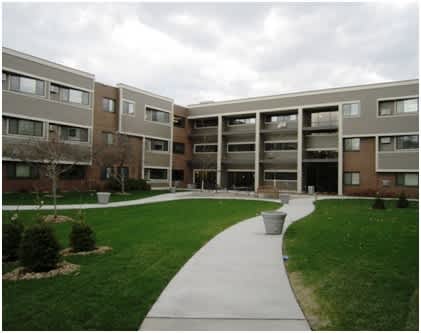 A long building with a walkway in front of it.