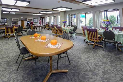 A dining room with tables set for a meal.