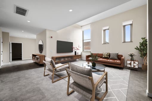 a living room with a couch and chairs and a television
