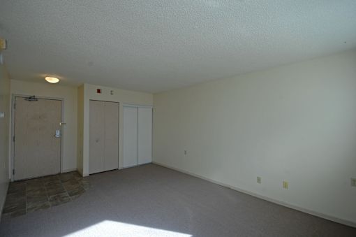 A room with a stone floor and white walls.