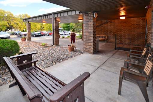 A wooden bench is in front of a building.