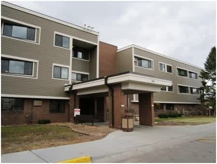 A multi-story apartment building with a covered walkway.