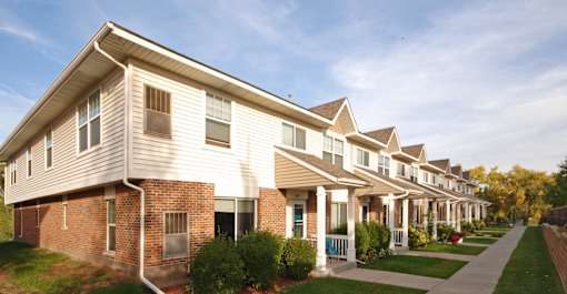 A long row of houses with a clear sky above them.