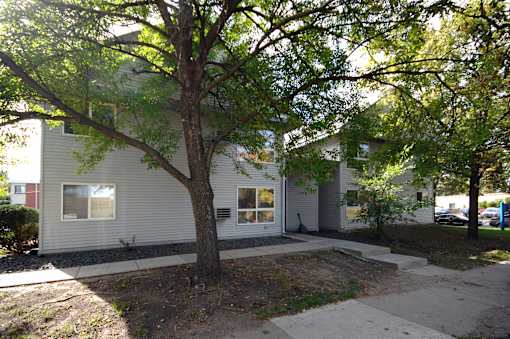 A tree in front of a house.