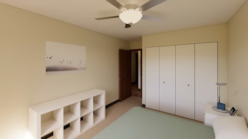 A room with a ceiling fan, a picture on the wall, and a white bench.