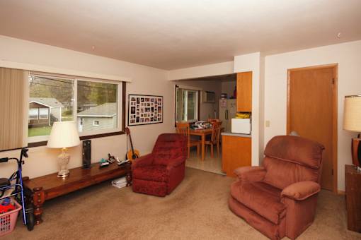 A living room with a brown recliner and a wooden coffee table.