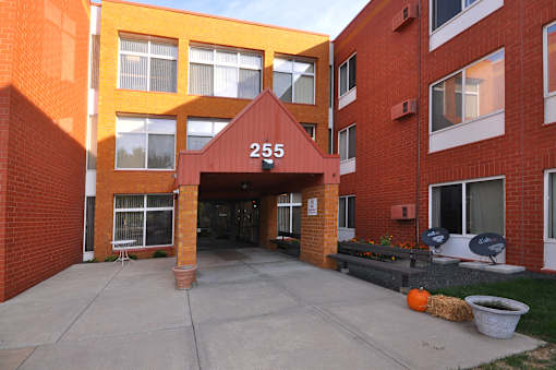 A red brick building with the number 255 on the front.