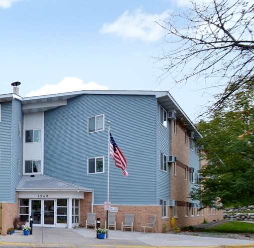 A blue building with an American flag on top of a pole.