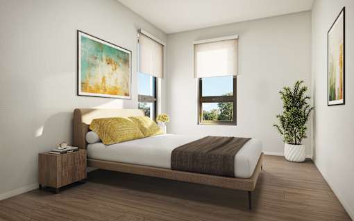 A bedroom with a bed, nightstand, and two windows.