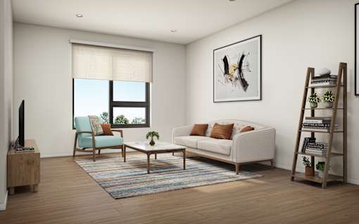A living room with a white couch, a blue chair, and a wooden floor.