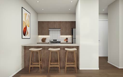 A kitchen with a bar area and two stools.