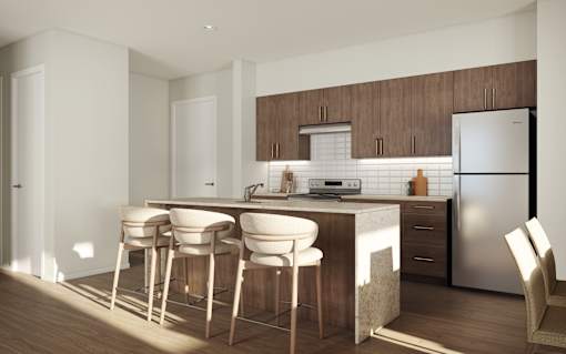 A kitchen with a bar area and a refrigerator.