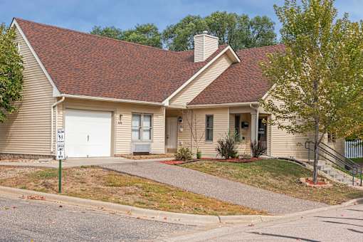 A house with a brown roof and a white garage door.