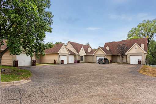 A large house with a driveway in front of it.
