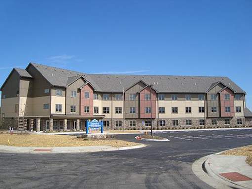 A large building with a blue sign in front of it.