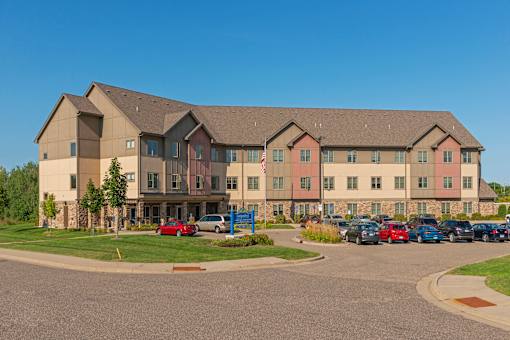 A large building with a parking lot in front of it.