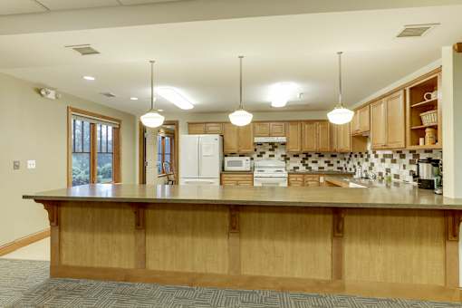 A kitchen with wooden cabinets and a large island.