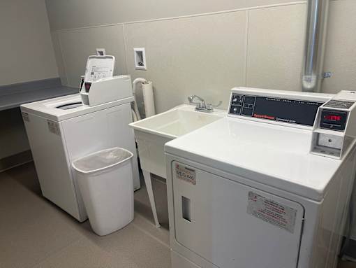 A white washing machine and dryer in a laundry room.