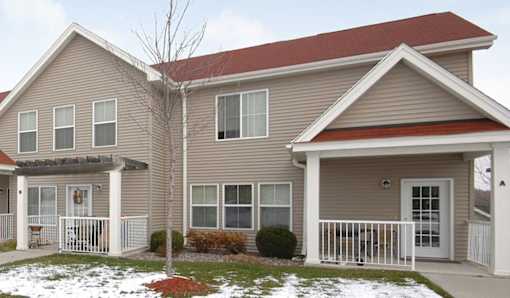 A house with a red roof and a grey siding.