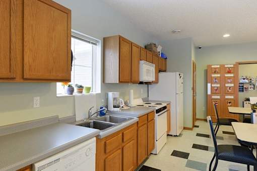 A kitchen with wooden cabinets and white appliances.