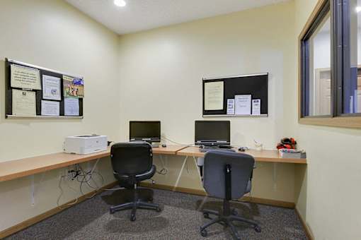 Two computers on a desk in an office.