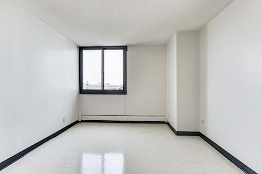 A white room with a window and a black frame.