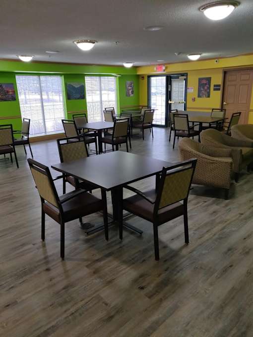 A large round table surrounded by chairs in a room.