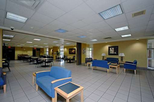 A large room with blue chairs and tables.