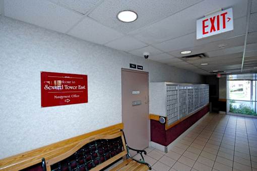 A sign for the Seventh Tower East Management Office is on the wall.