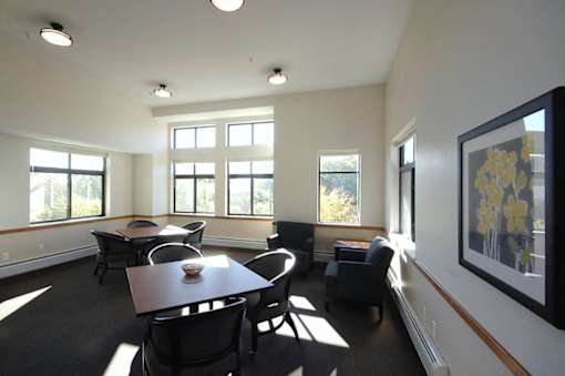 A dining room with a table and chairs.