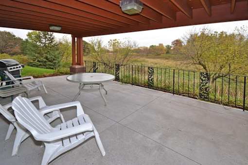 A patio with a table and chairs.