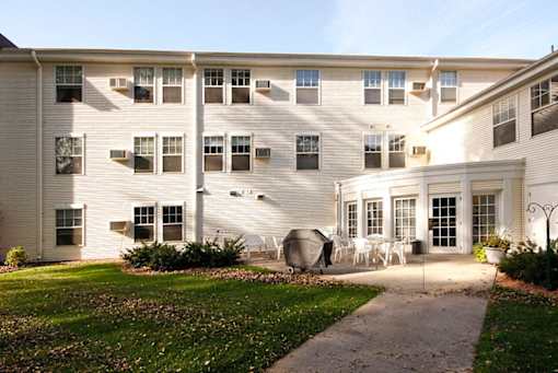A white building with a white lawn in front.