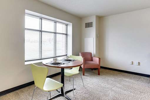 A table with chairs around it in a room.