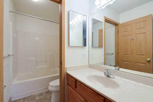 A bathroom with a white sink and a white toilet.