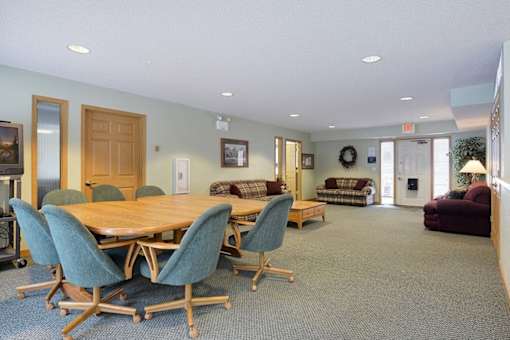 A conference room with a large table and chairs.