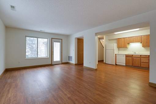 A room with wooden floors and white walls.