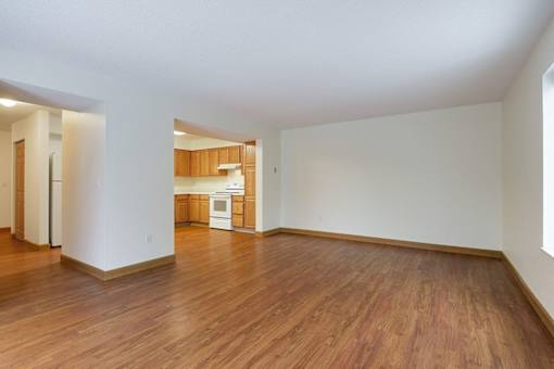 A room with wooden floors and white walls.