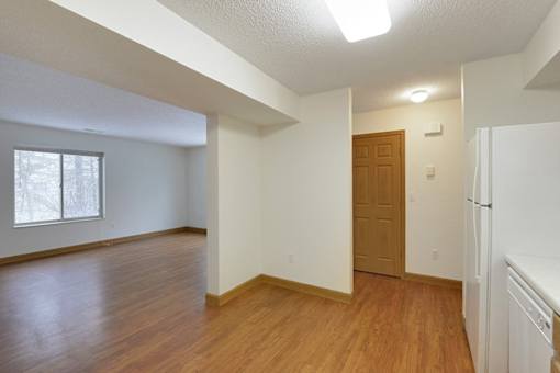 A room with wooden floors and white walls.