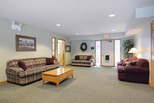 A living room with a couch, chair, and coffee table.