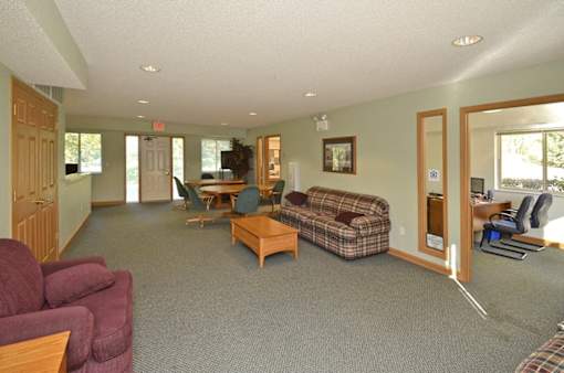 A living room with a couch, chair, and table.