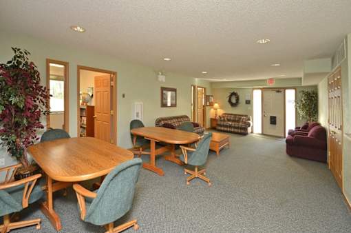 A room with a wooden table and chairs.
