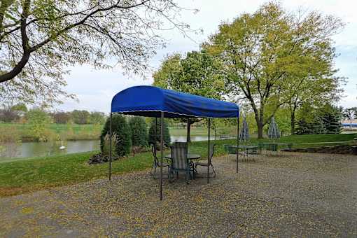 A blue canopy is over a picnic table.